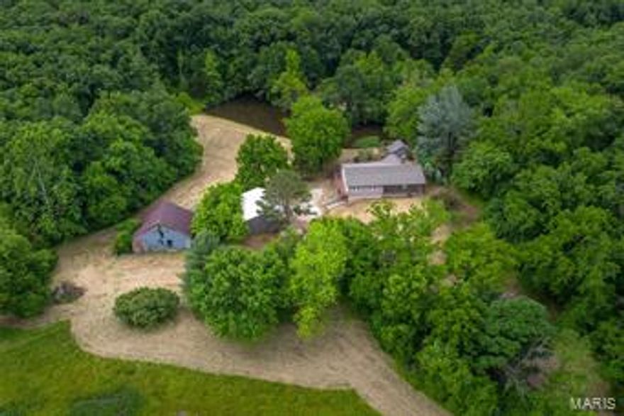 This gorgeous home is a little piece of paradise. With a nice lake to entertain with and a cool creek right along the driveway there is no shortage of things to do at this home. The home itself is wonderful with multiple fireplaces, a partially finished walk out basement, and some large out buildings for mechanic types or any hobby for that matter. Come out and give it a look!