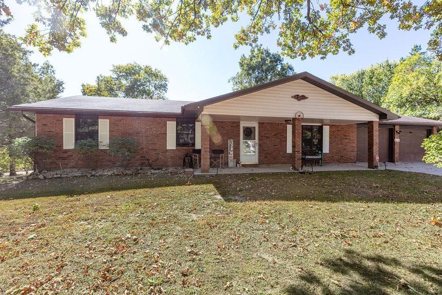 Beautifully updated home just MINUTES from Fort Leonard Wood.  Located on a quiet street with large lots, this home has LOTS OF PARKING and an oversized garage with room for workshop area.  The home has updated floors and bathrooms which were all completed with both good quality and taste.  But, the backyard is the big secret!  Rainy morning?  No problem!  Relax on the COVERED DECK with a peaceful view of the timber.  The fenced back yard is great for keeping critter out or pets IN!  Two outbuildings give plenty of OUTDOOR STORAGE.  Not enough?  How about a 12x30 guest house? This SHOUSE located on the back of the property is completely insulated with a 1/2 bath piped in directly to the sewer. Would make a great workshop, guest house or game room!  This home has so much to offer!