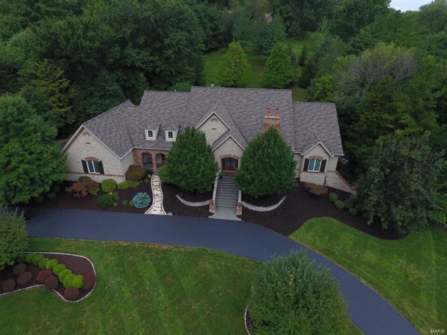 This beautiful 1.5 story DeShetler built Executive Estate offers a 2 story great room, spectacular gourmet kitchen with an adjoining breakfast room, hearth room, formal dining room and a den with custom built-ins, woodwork and a fireplace. There is a large wet bar area that is wonderful for entertaining. Grab a cocktail at the bar and head out to the patio and take a dip in the salt water in-ground pool or relax in the built-in hot tub after a long day. The main floor master suite offers a gas fireplace, large bathroom with his and her vanities, separate shower and spa tub. Also on the main floor there is a second bedroom, full bathroom plus two half bathrooms and a laundry room. The 2nd floor has 2 additional bedrooms and 2 full baths. The expansive finished lower level includes a theater room, office, fitness room, game room, family room with a fireplace and a full bath.  Some recent updates include exterior painting, hardwood flooring, exterior lighting and a new roof.