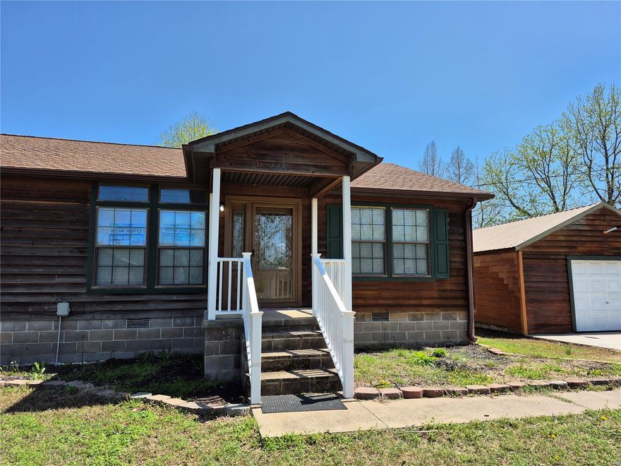 Back on the Market, Buyer's Financing Fell Through. This home passed 100% Financing USDA Requirements. Grab your agent and see it today. Beautiful 3 Bedroom, 2 Bath Home with a Detached 2 Car Garage all wrapped in Cedar Siding. The home sits on nearly .6 acre flat, corner, lot. A Covered Entryway leads to a Large Family Room with New Carpeting,  then a Breakfast Room/Dining Room with Rich Vinyl Flooring. A Generous Sized Kitchen with tons of cabinets and a Lunch/Dinner Bar is just one of the highlights in this Fantastic Living Space. Your very own Ensuite has a Big Bedroom, Walk-In Closet, and a Fantastic Bathroom with Dual Sink Vanity, Shower, and a Tub with Stone Accents and Columns. Two additional Bedrooms and another Full Bath make this the right size for a family. An Extra-Wide Concrete Drive takes you in to the Detached 480 Square Foot Garage.
This Home is Absolutely Ready to Move-In and the Owner will finance for a Qualified Buyer. Call today and own one of the Nicest Homes in Town