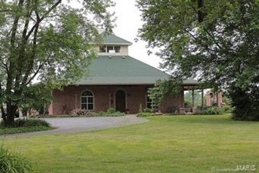 Extraordinary Hobby Farm! 16 Solar Panels generating 2800 KW keep the utility costs at a minimum. Orchard has 200 trees (several varieties) plus 3 acre vineyard  & blackberries with irrigation. 40x60 Barn with workshop is plumbed for an apartment.  House was designed to be a B&B. Each of the 4 bedrooms have private baths.  Custom kitchen has wine rack and center island. Wood burning fireplace in the heart of the home. Sun room finished with mosaic tile and hot tub off the master bedroom.  Enjoy the custom shower with multiple shower heads for a spa like experience every morning. Patio just off the living area has lots of seating area around the outdoor fireplace that features a pizza oven. Perfect view of the vineyard. Excellent location for wine tasting. Basement is finished and features dance studio/ exercise room, storm bunker, workshop, storage with shelves and lots of natural light. Unique property barely outside city limits. Fantastic opportunity!