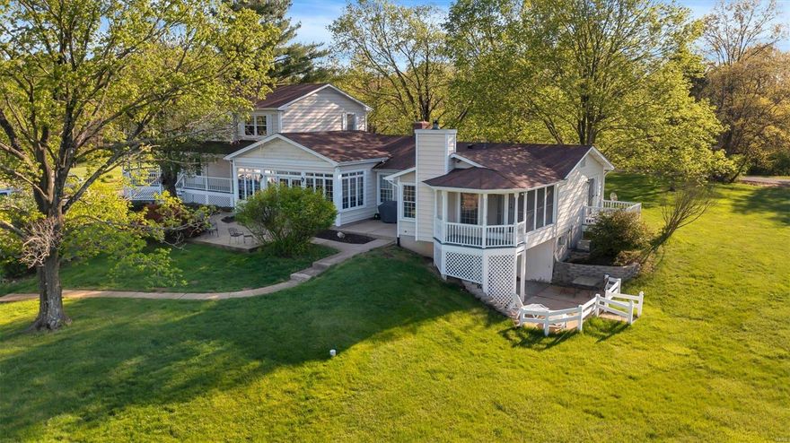 Welcome to your dream home in Wildwood! This stunning Victorian-style farm house is a true masterpiece. Three bedrooms upstairs, including a spacious primary suite, offers plenty of space while the separate dining room and large kitchen create room for hosting and making memories. The main level laundry provides convenient living, while the sun room is the perfect spot to relax and enjoy the natural beauty. The connected guest house offers a primary suite, half bath, and full kitchen upstairs, as well as another ensuite downstairs. Separate entry and walk-out access provide privacy and flexibility. Large garage workshop can accommodate up to 10 cars and features a full bathroom. Additionally, the separate barn with power and AC includes five stalls and a lounge that overlooks the arena. The love and care that has been poured into this property is evident throughout, making it a truly exceptional place to call home. Additional Rooms: Mud Room