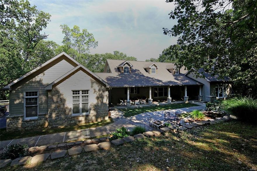 NEW PRICE!!Outstanding custom built 1.5 sty.on 5+ acres in heart of Wildwood. Privacy, wooded bluffs, gardens & wildlife right outside your door.Designed by original owners featuring large picture windows w transoms, job finished wood floors on main, cathredral & 9' ceilings, 9'basement pour, beautiful white millwork thruout, 75 recessed lite fixtures, gourmet kitchen boasts custom Wood Mode white cabinets (some w. glass fronts) Kohler cast iron dbl. sink, double ovens (1convection),trash comp, Bosch dishwasher, custom range hood, 7' X 5' center island W. breakfast bar, microwave, adjacent to
laundry room w. planning desk & storage cabs .All low-E windows, 3car side entry drywalled gar., private tree shaded patio w. fountain, huge deck, storage shed & dog kennel included. Luxury master bath w. adult height double bowl vanity, glass block shower,, heated whirlpool tub, dbl walk-in closets. LL Kit, bedrm & bath. Hardie board ext.,Waterhout Const. truss & stick built. Home warranty incl.