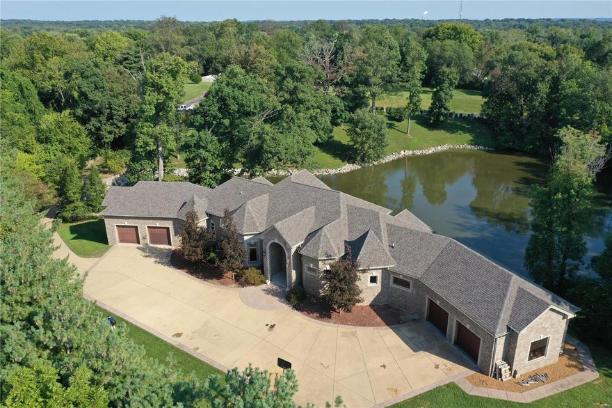 Resort Style Living. Never Leave Home.  Immaculate brick home with 6,156 square feet of living space, sitting on 3.8 acres with a water view.  Gated entrance with long private driveway.  The custom kitchen features granite countertops, custom cabinetry, and Premium Stainless Appliances.  The kitchen leads out to a large main-level composite deck.  Soaring tray ceilings and the windows provide stunning views. There is an upper loft area that adds to the entertaining space.  The main level Master bedroom suite features a double shower and a jetted tub for two.  All of the bedrooms have private full baths located in the bedrooms, so they can be In-law suites.  The main level features an office and laundry.   The lower level features another kitchen with stainless appliances and granite countertops, an exercise room, a living area, recreation, and a covered patio.   Multiple areas where a pool can be installed.  This home is perfect for entertaining and privacy with potential for growth.