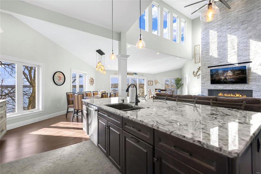 The ultimate lakeside retreat! Boasting 5 bedrooms - including a primary suite, jr bedroom suite, & custom bunk room all with ensuite bathrooms - this is the perfect spot for big families & your guests. Get the party started in the open-concept kitchen/living area. Entertainers will love the 3-story deck, with stunning, unobstructed main channel views. You've got your own putting greens for some serious family fun. When you're not perfecting your swing, the updated (2019) dock w/ 12x36 boat & 12x12 PWC slips & are just a few steps away. 

This home isn't just fun in the sun - it's got great bones too, ensuring a worry-free retreat. 2x HVAC units - 1 replaced in 2013 (electric) & the other in 2018, 2x 50 gal. water heaters new 2019, & whole-home water softener take "maintenance free" to a new level.  The new (2023) roof & cement board siding (2019) mean hassle-free living for years to come.