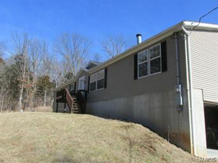 Amazing contemporary manufactured Home offers nearly 2200 Square Feet of Living Space & a Full, Walk-out Basement!  Potential of Mother-in-Law Quarters (convert Family Room) because this is a huge home in a very private setting!  Beautiful level backyard with large concrete Patio.  Family Room has Wetbar and two ceiling fans.  Divided Bedroom Floorplan.