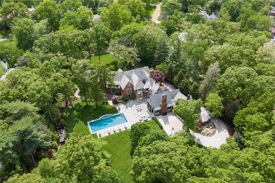 Listed on the National Registry of Historic Places, this 1927 Maritz & Young masterpiece has been restored to original splendor while evolving into superb modern living. A grand reception hall and sweeping stair rotunda unite inspiring gathering spaces. A timbered living room features leaded glass windows, carved stone fireplace, imposing chandelier and a stained glass sunroom. An exquisite paneled dining room with plaster relief moldings & ornamental gates opens to the wine cellar  and bar. A sophisticated library hosts floor to ceiling bookshelves and a fabulous bay window seat. A generous kitchen boasts a La Cornue stove & walnut floors and an expansive family room frames the park-like grounds.  Additional amenities include a 2nd floor laundry, 3rd floor family room, lower level screening, billiards, exercise & massage rooms, a carriage house, saltwater pool, stone patios & gazebos, brick & metal fencing, 4 car garage and 2.55 sprawling acres! Additional Rooms: Mud Room, Wine Cellar