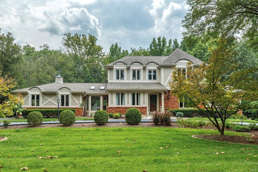 Beautifully renovated brick 1.5 Sty in premier Frontenac location. Open floor features light-filled rooms with oak hardwoods, soaring ceilings & detailed trim work. Gracious entry foyer opens to private study, formal dining room & living room with wet bar, floor-to-ceiling stone see-through fireplace & barrel-vaulted entryways that lead to expanded family room with wide bay windows, fireplace & skylights. Designer kitchen with glazed bisque cabinetry, granite countertops, stainless steel appliances & 7’ black walnut island adjoins vaulted breakfast room. Spacious master bedroom suite combines the enjoyment of a brick fireplace with sitting room & luxury bath with jetted tub. Oak staircase accesses 4 additional bedrooms & 2 full baths. Lower Level entertainment space includes recreation room, game room & gathering bar plus workout room & full bath. Situated on a parklike 1+-acre cul-de-sac lot with deck, paver patio & oversized 3-car garage. Award-winning Ladue School district.