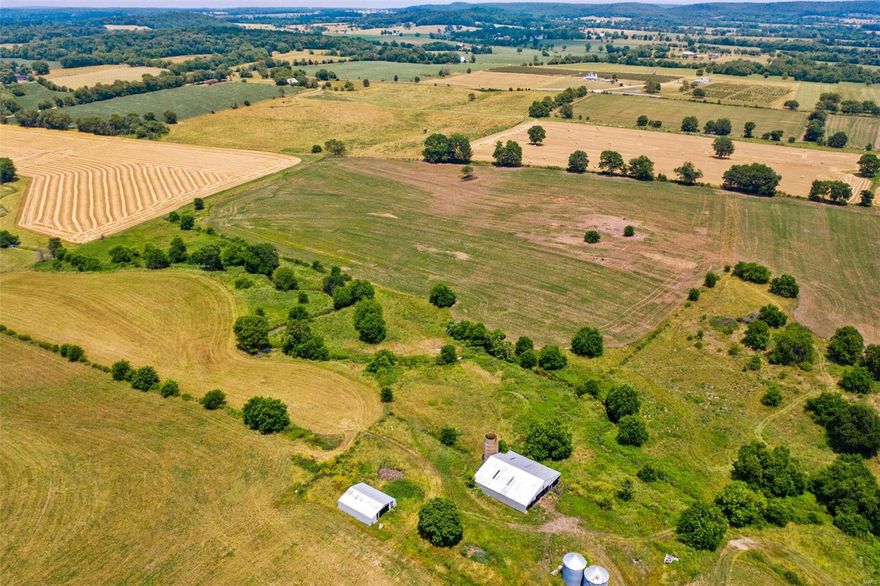 It's all about the land! 120 acres m/l of beautiful farmland. Small creek with two artesian wells. Outbuildings, great location, perfect for cattle, crops, recreational, building.