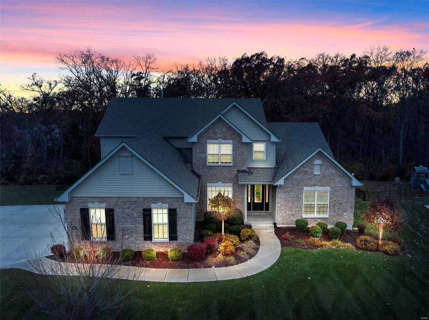 Nestled on a serene .77-acre wooded lot, this exceptional home offers 5 bedrooms, 4.5 baths, and over 5,600 sq. ft. of living space designed with comfort and elegance in mind. The main floor features a luxurious primary suite with a spa-like bath, a hearth room with a gas fireplace, and a chef’s kitchen boasting quartz countertops, stainless steel appliances, a gas cooktop, double ovens, an island, a breakfast bar, and a walk-in pantry. Hardwood floors and 9-foot ceilings add to the charm.

Upstairs, find spacious bedrooms with walk-in closets, a Jack-and-Jill bath, a princess suite, and a bonus room. The beautifully finished lower level includes a second primary suite, a custom bar, a game room, and a gym. Dual HVAC systems, a 3-car side-entry garage, and ample storage complete the home.

This home is a true gem—schedule your private tour today! Additional Rooms: Mud Room