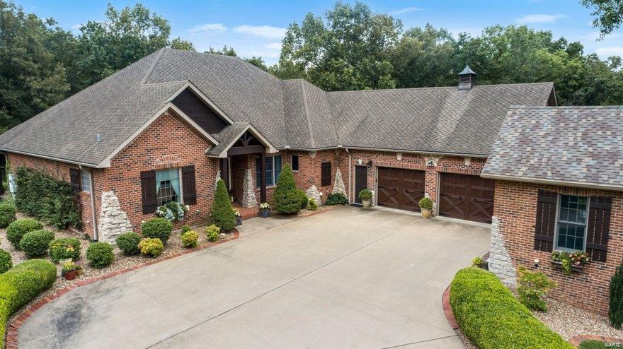 Just moments from town, you’ll discover this meticulously crafted, tranquil property which sits among a collection of breathtaking properties. The home with 3.2 acres offers amenities such as an additional garage, a hobby area, and a WiFi whole-home entertainment system. The large white oaks, frequent deer sightings, and private pond with a fountain offer peaceful views from the covered patio of the home.  In the heart of the home you’ll find the modern kitchen equipped with top-of-the-line appliances, a sprawling granite island, and custom cabinetry The kitchen seamlessly flows into the hearth room, featuring one of the home's three fireplaces. The finished walk-out basement is a true entertainer's haven. Complete with a kitchenette, this versatile space is perfect for hosting events. The home offers 4 bedrooms and 3.5 baths and is one of only two homes on this cul de sac making it kid-friendly with low traffic!