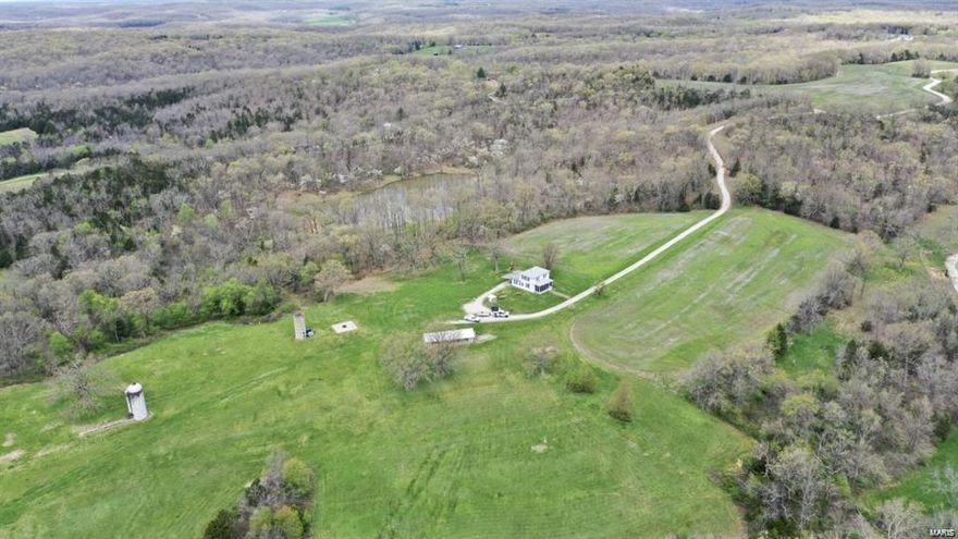 Located on 326+/- acres sits a quaint little farmhouse. Interior has been completely updated which includes 3 bedrooms and 3.5 bathrooms. There is a large outbuilding perfect for storing equipment or for a workshop. Not only does this property have beautiful scenery, but it also is home to some great deer and turkey hunting! The property also has spring fed creeks, beautiful timber and 55 acres of tillable ground. With a gated private entrance, you have finally found your piece of privacy and serenity.