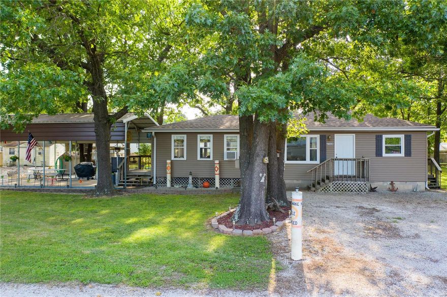 MOVE IN READY AND ALL FURNITURE STAYS WITH THE HOME! This 2 bed, 2 full bath home has been completely renovated, and ready for its new owners. As you walk in to an open floor plan with an over-sized family/gathering room that walks out to a deck with stairs leading to patio and fire pit. Main floor has 2 bedrooms & a 2 full bathrooms. This home has a new roof, new paint throughout, new flooring throughout, new stainless steel appliances, new ceiling fans and light fixtures. Property features a utility shed &  large carport. All of this is located less than a mile from the lake, with many camping, swimming, & recreational activities nearby. Whether searching for a wonderful lake home or a seasonal get-a-way, this one has it all!