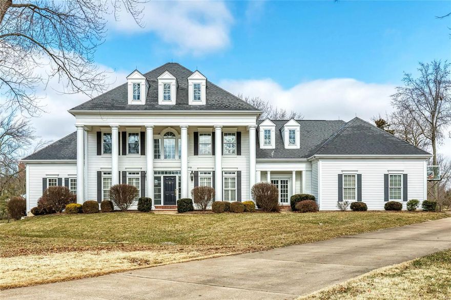This spectacular 1.5-sty Southern Colonial features over 6000 sf of living space enhanced by oak hardwoods, extensive millwork & expansive windows overlooking parklike grounds. Impressive 2-sty hardwood foyer leads to private study with French doors, elegant dining room & stunning great room with see-through fireplace, entertainment center & wet bar. Chef’s kitchen with beamed cathedral ceiling, 42” glazed cabinetry, granite countertops & center island adjoins light-filled breakfast room with convenient planning center & hearth room with floor-to-ceiling stone fireplace. Vaulted master bedroom suite offers an appealing retreat with wide bay window, His & Hers walk-in closets & luxury bath with Jacuzzi. T-staircase accesses 3 additional bedrooms, 1 with ensuite bath, & hall full bath plus office & bonus room. Walkout Lower Level includes recreation room, game room with wet bar, office, workout room, 5th bedroom & full bath. Situated on a 1+ ac cul-de-sac lot with deck & 3-car garage.