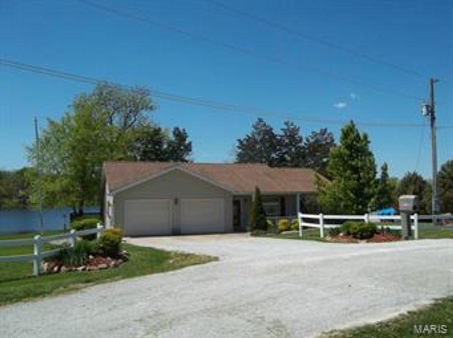 If you are looking for a little piece of Heaven on the banks of Lake Hannibal then look no more! This 2 bedroom, 1 1/2 bath, ranch style home offers one level living and has been very well maintained!  In 2008 a beautiful Family Room was added on the back with a vaulted wood ceiling, gas Fireplace, and large windows overlooking the lake!   11 x 15 screened porch off FR and a wood deck are added ways to enjoy the lake, waterfall in back yard, established trees, and the 3 lots that complete this property! The eat in kitchen has Oak cabinets and the range, refrigerator, dishwasher, washer & dryer all convey as well as all window treatments, 6 ceiling fans and garage door openers & remotes.  $360 per year association fee includes free use of Lodge.  Other amenities include 6 panel doors, vinyl clad windows, and a 2 car attached garage with extra storage space.  Out-building, flag pole and martin house all convey.  Beautiful Landscaping!!  LP tank is leased from MFA in Palmyra.