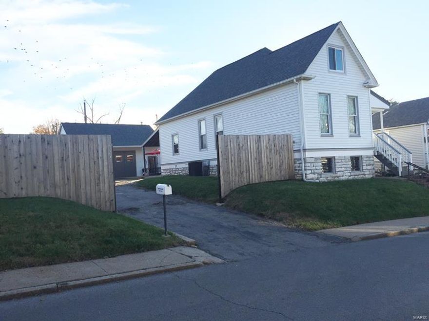 This 1,626 sq ft home is situated on a TRIPLE LOT with a driveway and an 1,100-sq. ft garage/studio space.  It will go fast! The original historic farmhouse features some original millwork and many clever updates. Living space is versatile with four large rooms on the first floor and large bedrooms upstairs. The garage/studio space is perfect for a home business or a hobbyist. Garage was renovated in 2011 and features an additional bathroom, heat/AC, and shop sink and counter. Garage roof and gutters were new in 2013.  The large lot (8,718 sq ') is enclosed by an 8' cedar privacy fence, new in 2014. The house features new front porch, roof, gutters, siding and paint. Don't forget the covered patio and full, walk-out basement. All this great space is located just 1/2 a block from the thriving Morgan Ford strip and 5 short blocks from Tower Grove Park. This is where you want to live, work and play! Additional Rooms: Mud Room