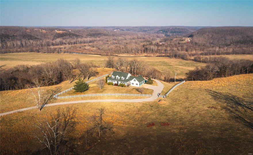 Located In Pulaski County Missouri,  Two Rivers Ranch is the property you have been looking for! This property raises the bar for luxury cattle ranch. Only minutes from town as you pull off the state highway you have a 3/4 mile private asphalt drive to an over 4,800 m/l sq ft custom farmhouse. This is where the Big Piney River & The Gasconade River meet. This property has captivating views from every angle, fenced and cross fenced pastures, river views from the house, frequent Deer and turkey sights. This 4 bed 3 & 1/2 bath home w/ an attached garage has a full basement, hardwood floors throughout, wrap around porch to take in the views of the river & countryside, & an in ground swimming pool. This working cattle farm will run 80 head conservatively w/ rotational grazing and cutting enough hay off the river bottoms for winter feeding. All steel working pen, shed and hay barn located away from the home in a central location for easy truck loading and hauling. Owner is a licensed agent.