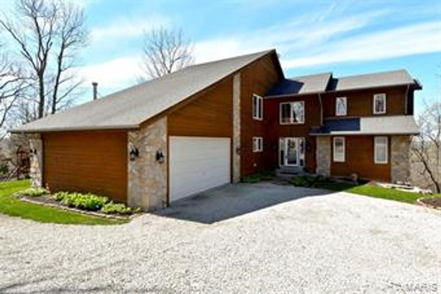 This 4 BR, 4 Bath custom home sits on nearly 14 secluded, wooded acres at the end of a tranquil gated lane! Lots of windows throughout to let in natural light & beautiful views of nature; Two story Great Room with floor-to-ceiling stone WB FP; Updated kitchen with hdwd floor, granite counters, tile backsplash, crown molding, under-cabinet lighting and SS appliances; Breakfast room opens to three-season porch with free-standing WB stove; Office with hdwd floors and slider to deck; MF Bedroom and Full bath; UL Master Suite features cozy WB FP & sitting area w/ gorgeous wood paneling & built-ins; Updated Master Bath with crown molding,  heated tile floor, oversized frameless glass shower and jetted tub; Second BR with private bath; Finished walk-out LL features 10 ft pour,wet bar, rec room, full bath & fourth BR; Enjoy the beautiful surroundings from the wraparound deck with pergola; Fully insulated outbuilding/garage has new roof and it’s own power; Central Vacuum; New carpet throughout. Additional Rooms: Sun Room