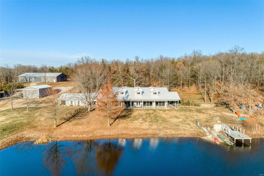 UNIQUE PRIVATE 60 ac RETREAT. This 60+/- ac piece of heaven offers so much for the entire family.  5 bd 4 bath home with a very unique 65x35 completely open great room (radiant floor heating) with a wall of sliding doors that open to a 70x12covered porch overlooking the 6 ac lake featuring - island, dock, beach, stocked & spring fed.  Main floor: Great room, Master suite, living room, dining and kitchen w/ 2 pantries, laundry area, 1 cg attached.  Second level offers to large bedrooms w/dormers & their own full bath plus a bonus area. There is a small pond & spring.  Perfect property FOR THE HORSE LOVER, Newer 60x100 indoor arena w/kickboard & sand floor; 30x50 Gambrel 2 story barn w/10 ft lean to and 5 stalls, loft & tack room; 42x55 garage/workshop 15 ft lean to, ½ is insulated & wood stove/shop heaters, compressor; 24x40 RV gar w/12x40 lean to(elect). Private Trails to ride horses, 4 wheelers, hiking, fishing, you get it all. This could be a company retreat or bed and breakfast.
