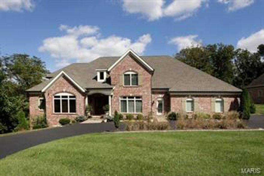 4-year old custom home on .81 acre property with main floor master suite and finished walkout lower level.  Very private cul-de-sac lot with plenty of room for a pool.  14' beamed ceiling center island kitchen with adjoining hearth room and wet bar shared with great room.  Wolf, Viking and KitchenAid appliances.  Master suite with 12' ceiling height, deluxe bath with Kohler air tub, granite, heated flooring and his & her walk-in dressing rooms.  Great room with 11' ceiling, fireplace and full elevation of windows overlooking the property.  Library with custom casework and dining room with butler's pantry.  2nd level with 3 bedroom suites plus bonus room/5th bedroom.  Finished walk out lower level with walk behind wet bar, full bath and bedroom 6. 10-14' ceiling heights on main floor, 9' minimum on upper level.  Main floor laundry, 3-car garage.  This house can accommodate any sized family.