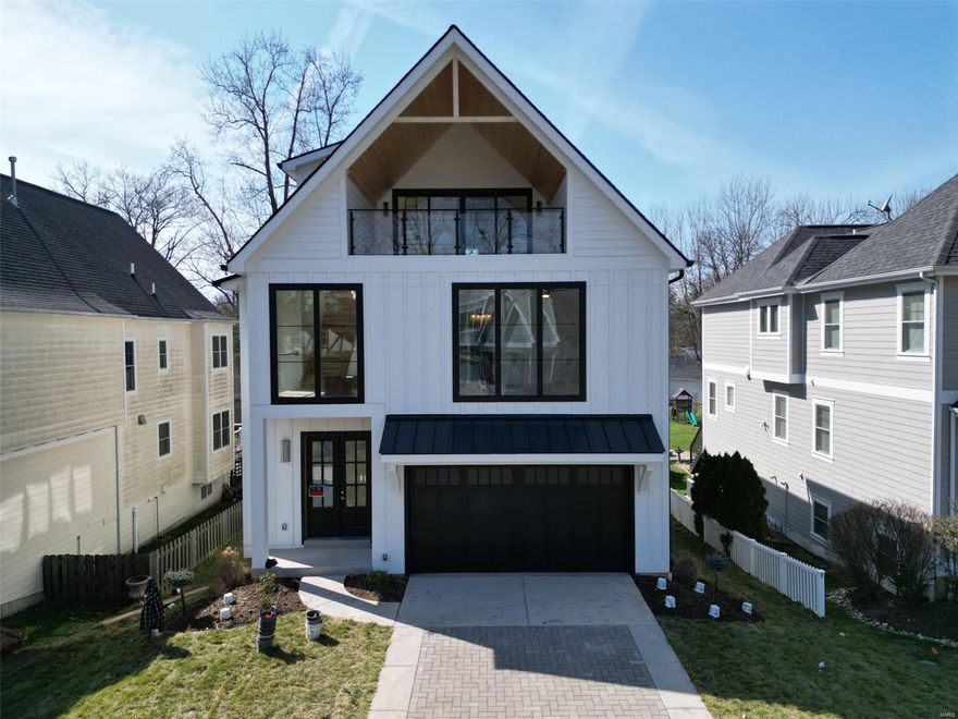Gorgeous new design for St. Louis, this home is sure to be the talk of the town! As soon as you enter, you'll be wowed by the tall ceilings, large windows & open floorplan full of natural light. The great room has a cozy fireplace & is open to the dining room & kitchen. The kitchen is sleek & modern with a huge center island, pantry & double ovens. A lovely patio is perfect for outdoor entertaining. Upstairs is the primary suite, with a luxurious full bath with dual-sink vanity & separate tub & shower—plus a spacious walk-in closet. Two more bedrooms share the hall full bath, & the laundry room is conveniently on this level too! Up another set of stairs, the finished space has an ensuite bath, & living area with access to the stunning covered deck that is the ultimate entertaining space. The finished lower level provides more space with a rec room, 5th bedroom & a full bath. The home has over 4,000 sqft of living space and an elevator stopping at all 4 levels.