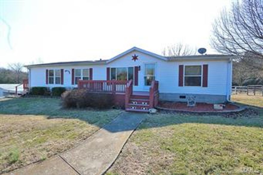 Immaculate 3 bedroom, 2 bath home on 1.75 acres just far enough out of town to give you the privacy you have been looking for!
but within a short distance of highway 67. The home has a 26x16, freshly painted, living room with wood burning fire place which makes the perfect place to cozy up in the evening or entertain with family & friends. The large kitchen has a center island/breakfast bar & lots of  beautiful cabinets, you won't mind cooking in this great kitchen.  A large dining room adjoins the kitchen & makes the perfect place to serve family & friends. Additional great features of the home include all new flooring professional installed & large laundry room.  The property has been divided up into 4 sections if you have horses or livestock. In addition the property comes with a 40x24 barn with electric, it has  2 horse stalls & two lean two's.  You will enjoy this home inside and out including the large deck. Call to see, at this price it won't last long!