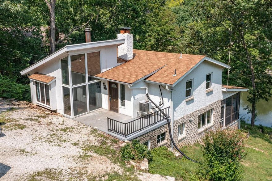 This unique art-deco styled 2 bedroom, 3 bathroom lakefront home is located in the desirable gated community of Lake Wauwanoka.   The covered back porch is the perfect setting for enjoying beautiful views of the lake while sipping your morning coffee or evening beverage. There is a unique glassed front room which is a sunlight filled delight.  The included TWO boat docks and 2nd waterfront lot make this lake house the perfect destination in the making with room for expansion.

700 acres of common ground surround the property. The lake boasts a white sand beach with covered picnic pavilion and kids play area.  Or, take your boat out to the middle, drop anchor and let your worries drift away!  There is even a community center which is available to rent for your private events.

DRIVEWAY TO BE RE GRADED AND NEW COMPACTED GRAVEL INSTALLED.  Lake Wauwanoka is 30 minutes from the St. Louis area yet it's worlds away from the hustle & bustle. See www.wauwanoka.com for covenants. Additional Rooms: Sun Room