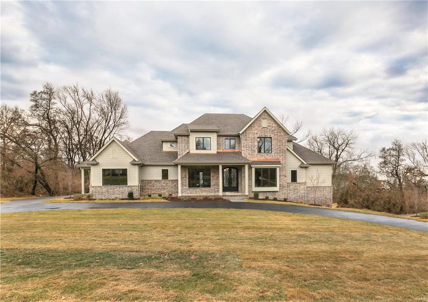 Come see this new Flower Homes Signature Design in Ladue featuring not only the gorgeous Master Suite but also a Guest/In law/Office suite on the first floor. The spacious vaulted beamed “Gathering Room,” with it’s dramatic floor-to-ceiling stone fireplace flanked by bookcases, is home to the gourmet kitchen, bright breakfast room & cozy family room. The beautiful double-door entry foyer off the front porch is flanked by the study & dining room. A covered side porch leads to the cubby area in the family foyer where the powder room and laundry and garage access are located. There is plenty more space for entertaining in the finished lower level where you will find a huge recreation room w/ a wet bar, and the 5th bedroom & full bath. Here you can walk out to a lovely private back yard suitable for a pool. Custom cabinetry w/granite tops, en-suite bedrooms, lots of hardwood flooring, built-in fridge, 48” SS range, circle drive, 13 x 26 ft patio, irrigation, humidifier and so much more.