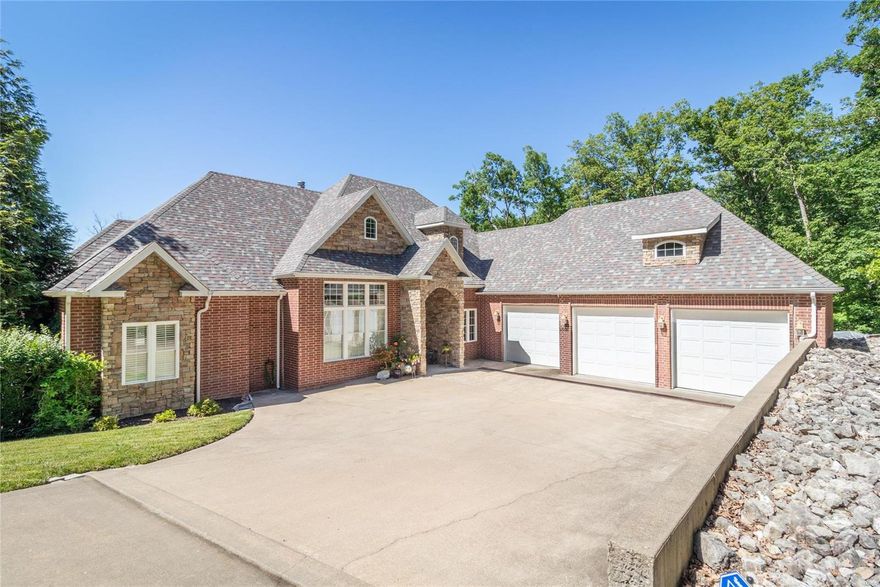 A stunning example of contemporary comfort and timeless elegance, this grand home offers the very best in lake-front living. The expansive layout spans 4,306sqft and offers 4 beds, 3 full baths and 1 half bath. Tall ceilings, wood floors and an abundance of natural light enhance the sense of space while a range of living zones are on offer including a dining area, the living room with a fireplace, a family room and a den/office. A suite of high-end appliances await in the gourmet kitchen along with custom cabinets, a pantry and an island plus there’s a wet bar for the avid entertainer. Extra features include granite counter tops, luxe master suite, lakeside John Deere room, sprinkler system, security system, an attached 3 car garage, 2 well dock and a picturesque 3.10-acre lot. Relax on the deck or the lower-level patio and admire the excellent lake views. Ha Ha Tonka, Sandy Beach and a host of lake attractions are only a short boat ride away as well! Additional Rooms: Mud Room