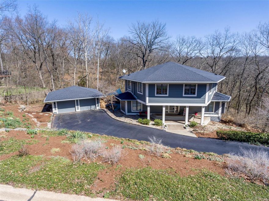 Contemporary home 4565 sq ft sits on a private, lushly landscaped lot backing to woods. Gorgeous 3 sty oak staircase. This home had a major renovation of the first flr & master bedrm suite. Many large windows let the light in & provide stunning views of nature throughout the home. Beautiful remodeled kitchen w/ huge granite center island, newer cabinetry, stainless appliances & walk in pantry. Family rm/ den  w/ wood-burning herringbone brick fireplace to relax. Spacious living rm w/ marble gas FP & floor to ceiling windows w/ a small deck. Large formal dining rm for your celebrations. Upstairs you will find a master bedrm suite complete w/ custom shower & freestanding soaker tub, private deck & walk in closet. Second floor laundry rm. There are 3 additional nicely sized bedrooms & another full bath w/ granite counters & double sinks. Downstairs you will love the awesome 2 tiered Lower Level w/ media rm , rec rm, & half bath. Walk out to the huge screen porch for outdoor entertaining.