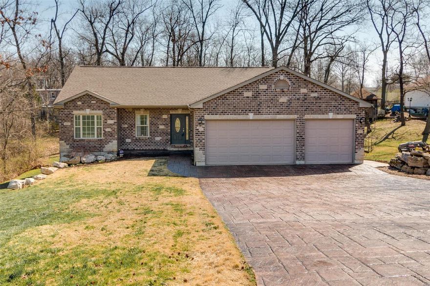 Rare opportunity at this price point. Custom Built Great Room Ranch, 3 Car Over-sized Garage with stamped concrete drive, Brick & Stone Facade, Just under a 1/2 acre, UNINCORPORATED St Charles County. Open floor plan with Vaulted Ceilings, hand scraped hardwood, huge Main Floor Laundry.  Master Suite with separate shower and jacuzzi tub, adult height vanities. Open Concept Kitchen with Stainless Appliances & Granite Counters. Extensive recessed lighting and beautiful Hardwood Trim throughout.  Ceramic Baths and Laundry. Open stairway leads to an expansive walk-out basement with full bath and wet bar rough-in, just waiting for your finishing touches. Endless exterior entertainment with large deck (2016) off the Kitchen Dining Area and a stamped concrete patio with access from the walk-out lower level. Newer Furnace and heat pump. Close to everything, in Francis Howell Schools, quick access to Page Extension and Hwy 94/40. Schedule your showings today, this one won't last!