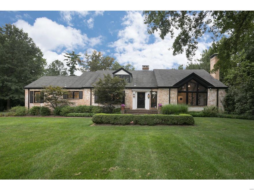 Spectacular & significant, this one of a kind home sits on a gated 1.65 acre lot in the heart of Ladue.  Get ready to be wowed when you walk in...the vaulted entry is flanked by the spacious living & dining rooms. Cathedral wood beamed ceilings, show stopping stone fireplace & leaded glass window are stunning! The updated eat in gourmet kitchen open to the family room is fit for a chef, banquet breakfast nook, butlers pantry & walks out to the side patio. The newly renovated master suite is over the top w/shiplap surround glass fireplace, picture windows to the pool & backyard oasis, and luxury bath with claw foot tub, 3 sinks, fridge and professionally finished walk-in closet, amazing! New heated, salt water & pebble tec infinity pool w/ hot tub make the perfect entertaining space surrounded by the parklike landscaped backyard. Charm abounds w/exquisite molding & architectural details at every turn.  Light filled estate in picturesque & sought after location.  Special offering!