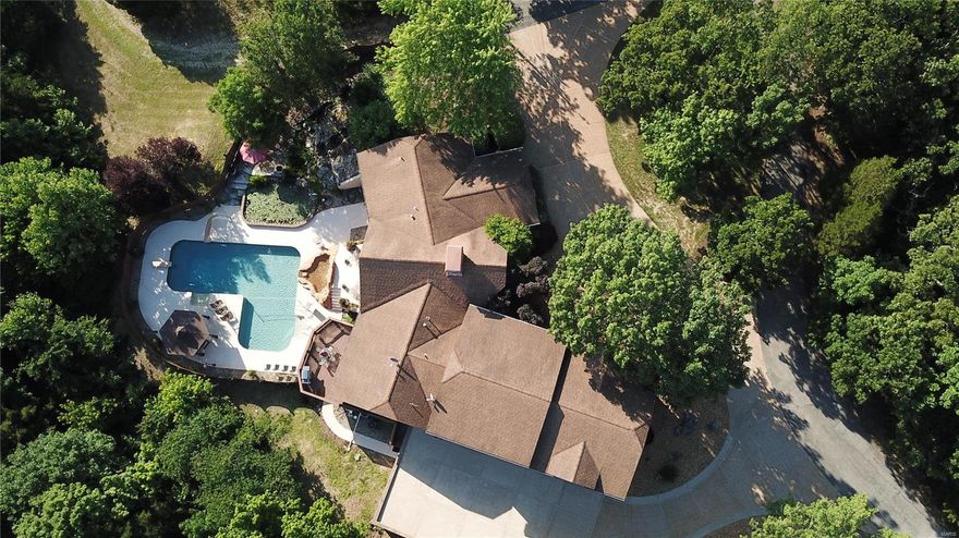 Unique resort style home sitting privately in the middle of 84+/- acres. Cozy by one of the 2 fireplaces in the winter or enjoy the peace & quiet by the waterfall/fish pond & in-ground pool in the spring/summer/fall. Lodge appearance offers wood ceilings in the main area w/oak floors, trim, 6 panel doors & railings. Kitchen includes island w/cooktop, custom cabinets, double oven, warming drawer, subzero refrigerator, trash compactor, Corian tops & pantry  -Laundry room off kitchen has custom cabinets & sink. The master suite has a jetted tub/separate shower, heated floor, heat lamp & Swanstone top. Lower level has bamboo floors, rec room w/wet bar, Corian tops, half bath, fireplace & built-in oak entertainment center - walk out to the outdoor pool/waterfall area w/ privacy fencing. Solar panels are situated on both outbuildings to service the home w/finished floors & electric. Numerous trails for riding/hiking and has a wet creek too. Hunters paradise for deer/turkey. Come to Paradise!