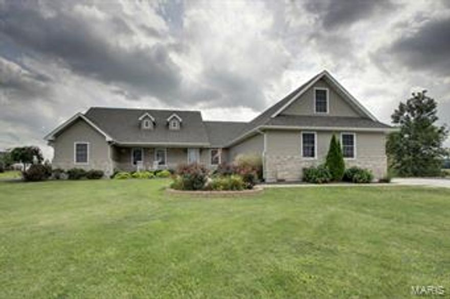 Impressive display of style, class, and functionality surround this beautiful home in Weatherstone, a country subdivision located just minutes west of Palmyra MO. Real hardwoods, intricate tile work, granite counter tops, vaulted ceilings, expansive master suite, and a geo-thermal heating/cooling system are just a few fine features to be appreciated. 10’ concrete pour with egress access/ladder, bathroom rough-in, and ample storage highlight the spacious basement which is ready for finishing touches if desired. Large 3-car garage with overhead recreation/storage room and climbing rock-wall are a bonus. Comfortable
covered rear porch allows a pleasing view of this level, one-acre lot with tons of possibilities; swing set conveys. Complete security system. Utility provider is Missouri Rural Electric Cooperative. Located 25 minutes from Quincy, IL and15 minutes from Hannibal, MO, the home is located within the Palmyra School District.