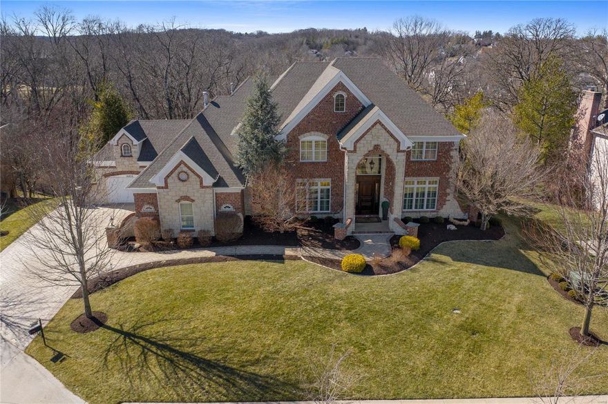 Stunning 1.5 story home loaded with updates/upgrades. Six BRs, 5.5 baths. Coffered ceilings, tray ceilings, crown molding, plantation shutters.  Hardwood flooring flows throughout the main level. New carpet on upper level. Fresh neutral paint. Open floor plan. Luxury main floor master with tray ceiling, bay window and relaxing bath with honed marble counters, soaking tub and oversized shower. Gourmet kitchen with quartzite counters, top-of-the-line SS appliances including Wolf 6-burner range, Wolf built-in coffee maker & Subzero fridge/freezer, walk-in & Butler's pantries. Kitchen opens to hearth room featuring Francois & Co mantle. Main & UL laundry. Finished walk-out LL with temp-controlled wine cellar, rec room, wet bar, media room, home gym, bedroom and full bath. Crestron Home Automation. Backyard is a private oasis and offers Heated/Cooled saltwater pool with waterfall. maintenance-free decking, partially covered patio, gas firepit and low-maintenance turf. Like New Throughout! Additional Rooms: Wine Cellar