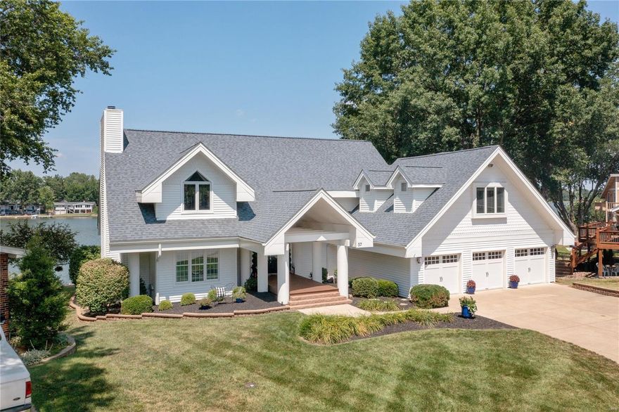 The premier lakefront home on Lake St Louise sits on nearly a half acre: this property is gorgeous from the street and from the lake! Everyone will enjoy the LSL lifestyle in this updated masterpiece. Space does not allow for the full list of renovations both inside and out but it starts with a completely redesigned master suite, three new bathrooms and a wet bar. The main floor upgrades include new wood floors, electric shades, custom draperies, an enormous entry chandelier, and high-end kitchen appliances. Most importantly, the views from nearly every room are spectacular, and the veranda overlooking the lake is serene! The renovated multi-purpose space atop its own private stairwell is your choice: a 4th bedroom, media room, WFH office, studio or whatever! In addition to the visible upgrades are many that just can't be seen like insulation, HVAC, and  the Tesla Charger; outside, improvements include a new roof, extensive landscaping, and free lake water for the irrigation system.