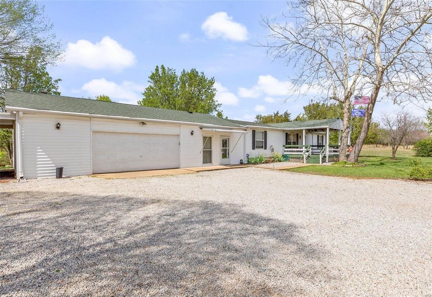 This home has a lot to offer. 3 bed, 2 bath with Living room & Family room, 2 oversize garages. Architectural shingles. Garages are 37x28, 1 carport is 10x20 and another is 20x30. Tractor shed is 14x12, wood shed is 16x12, utility shed is 8x8, toy shed 8x6. All Appliances stay. Tractor and implements stay. No value to the tractor. It has a front bucket grader blade. 65 Acre Fishing lake. 10 acres of land, suitable for horses or cattle. No pigs are allowed in the subdivision. Exclude curtains and mobile cabinet in kitchen.
