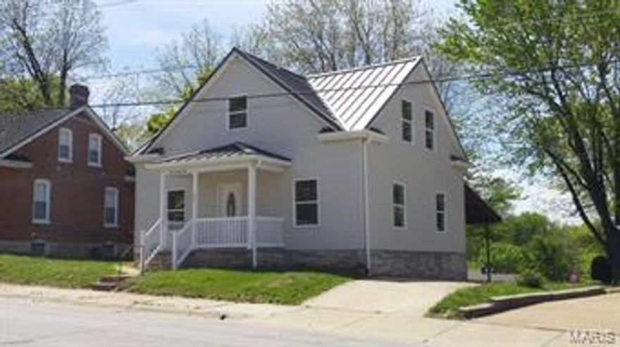 This house has been completely rehabbed due to a previous fire.  New windows, siding roof, wiring, plumbing, paint, carpet and improved interior layout.  3 huge bedrooms, upstairs beds both with walk in closets.  The 3rd bedroom is on the main floor (just add a closet!) Nice living room, formal dining room and kitchen area, all with neutral colors ready for the next owner to make their own.  2 full bathrooms as well.  There is off street parking with a driveway that leads to a huge back covered patio/parking area.  Large in town yard is also nice for a some recreational & gardening space.  Basement has laundry hook ups, a rough in for an additional toilet and nice space for storage & hobbies.  Call today!  It's a great place to watch summer time parades!