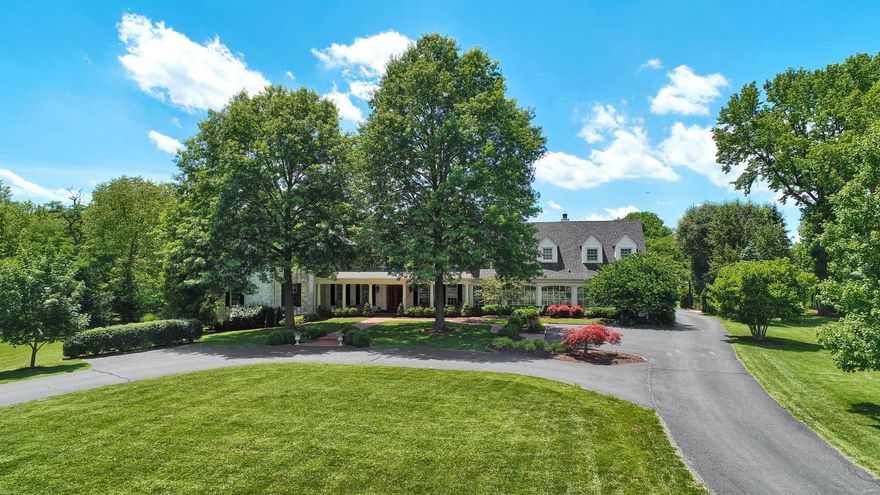 Magnificent French Colonial on 2 acres. This country estate features a barn with darling front porch, level yard w/ inground pool, hot tub, and waterfall. Elegant hardwood foyer opens to the living room, formal dining room with fp & adjacent game room! Updated kitchen with professional quality appliances, granite counters & breakfast bar w/fp that adjoins hearth room! The family room with fp is flanked by custom built-in bookcases. Glassed-in breezeway leads to main floor bedroom suite with a full hall bath. Master bedroom suite with fp, huge dressing room-closet, luxury bath w/Jacuzzi tub &  2nd closet w/private study/ office. 3 add'l bedrooms and 2 baths complete the 2nd floor. The 3rd floor has a large private bedroom suite. Main and 2nd-floor laundry. Lower level includes a media room, exercise room, full bath & wine cellar. This beauty is a must-see !!!! Who doesn’t want to be tucked away and in a serene natural setting behind the gates of a prestigious private lane?