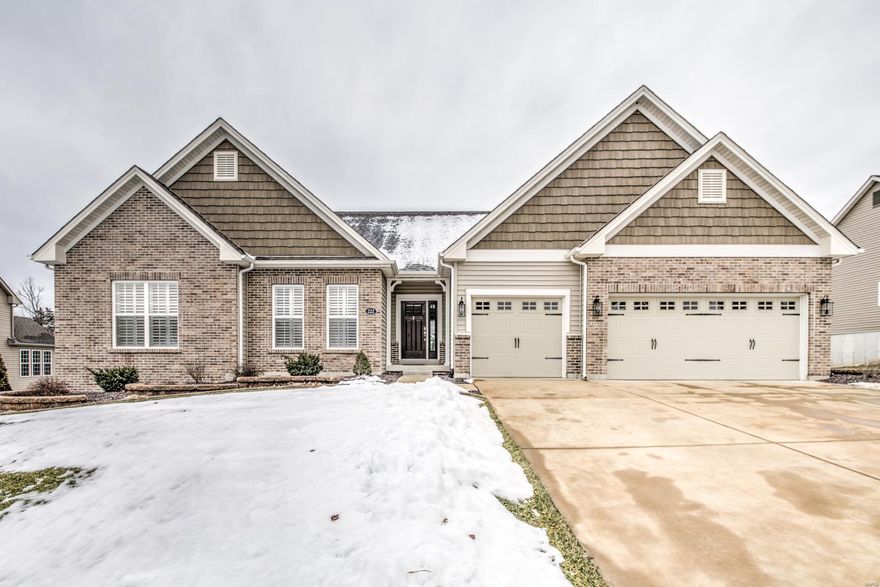 Beautiful brick ranch on a quiet street. Private lot backing to trees. Gourmet kitchen with 42-inch cabinetry, crown moulding, granite countertops,  center island, backsplash, under cabinet lighting, double oven, stainless steel appliances, and walk-in pantry. Luxury master suite with can lights, dual vanities, linen closet, walk-in closet, and soaking tub. Covered 13x12 maintenance free deck with ceiling fan and sun shade. Oversized three car garage with insulated doors and two foot extension. Walk out lower level with 42" wide staircase. Hearth room. Wide plank hardwood floors. Eight foot tall Low-E sliding glass door. Large 13x12 patio. Two panel doors. Upgraded carpet and pad. Electronic air cleaner. Humidifier. Professional landscaping. 30 year architectural shingle roof. Ten year builder warranty. Plantation shutters. In-ground sprinkler system. Quick access to 70 & 40. Close to Wentzville Parkway shopping and restaurants.