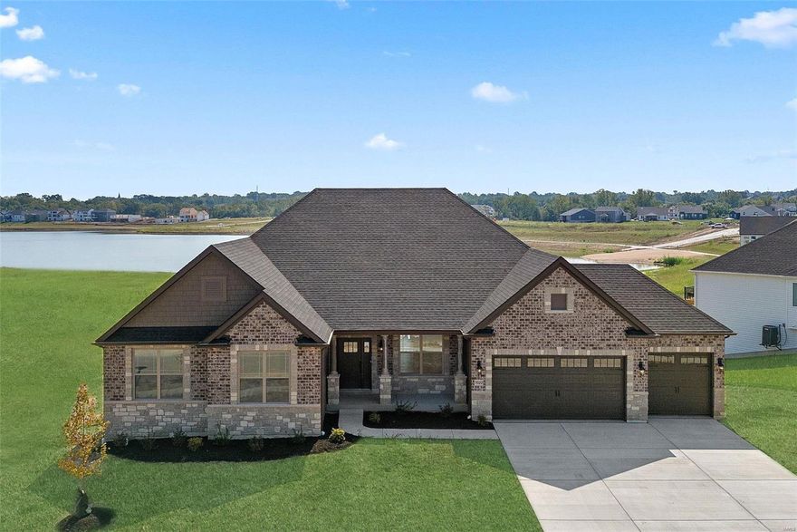 Backing to a beautiful community lake surrounded by a paved trail w/beach access for kayaking & paddle boarding, this stunning BRAND NEW Lombardo Homes ranch has a finished walk-out lower level w/wet bar, fireplace, bonus room, & private bedroom/bath teens or visiting guests will love. A tall wall of windows & 11' ceiling in the open main living area takes full advantage of the panoramic lake views. Well-appointed chef's kitchen features a huge breakfast bar island, granite counters, undercabinet lighting, double wall ovens, & a stone arch feature wall surrounding the 5-burner gas range & chimney hood. Primary suite overlooks the lake, w/2 walk-in closets & luxurious bath w/seated shower & separate vanities. Home office w/French doors. Cottleville Trails is a highly sought after neighborhood offering easy access to I-64/364 & fun shopping, dining, & entertainment venues in Cottleville & O'Fallon. Francis Howell (Central High) Schools. Gorgeous home w/many custom finishes! See it today! Additional Rooms: Mud Room