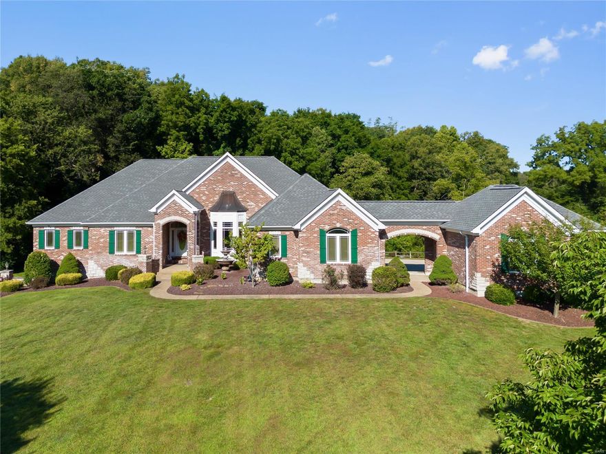 A little slice of heaven! This is your chance to own your own 5-acre park w/ a stocked lake. You will be mesmerized the minute you drive up the peaceful driveway on the wood bridge over the meandering creek. A truly custom-built ranch home w/ brick & stone arches, returns & a porte cochere between the two garages. Many high-end features; geothermal ground source HVAC, octagon shaped hearth rm w/ stone fireplace, 12 ft ceilings w/ arched wall of windows, 12 ft primary suite ceilings coffered, and dual walk-in closets. The expansive kitchen offers a huge butterfly island, custom staggered cabinets w/ crown molding & built-in wine rack. The fin walkout LL matches the main level design w/ brick landing, arched openings, pillars, octagon designed ceiling, wine room w/ metal gate, mini kitchen/wet bar & entertaining area. The LL also offers 4 addl rooms, 2 used as professional offices, one w/ an open space attached for a conference/sitting room & another full bath.