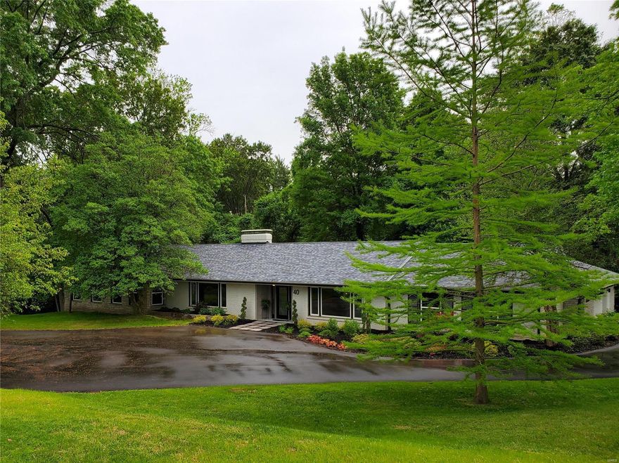 Imagine your days in this beautifully renovated ranch boasting an open floor plan, hardwood floors, and sunlit windows. Wake up to a shower armed with a panel of sprayers while the vanity mirror provides the music and news. Sip your morning coffee on the sprawling deck overlooking a private yard framed by majestic trees. Entertain family & friends in the open kitchen/living space boasting an impressive stone fireplace at its heart. Tired of dated homes? Be the first to enjoy the many modern luxuries: smart refrigerator, led faucets, designer fixtures, built in theater and more. Savvy buyers will discover 40 Conwood Lane boasts the advantages of new construction at a fraction of the cost (and stress): NEW windows, doors, roof, insulation, siding, masonry, plumbing, HVAC, electric, flooring, paint, kitchen, baths, deck and addition ensure you can RELAX and enjoy your home worry-free. All of this on 1 acre nestled between Frontenac and Ladue, near Westwood Country Club.  Duplicate Listing