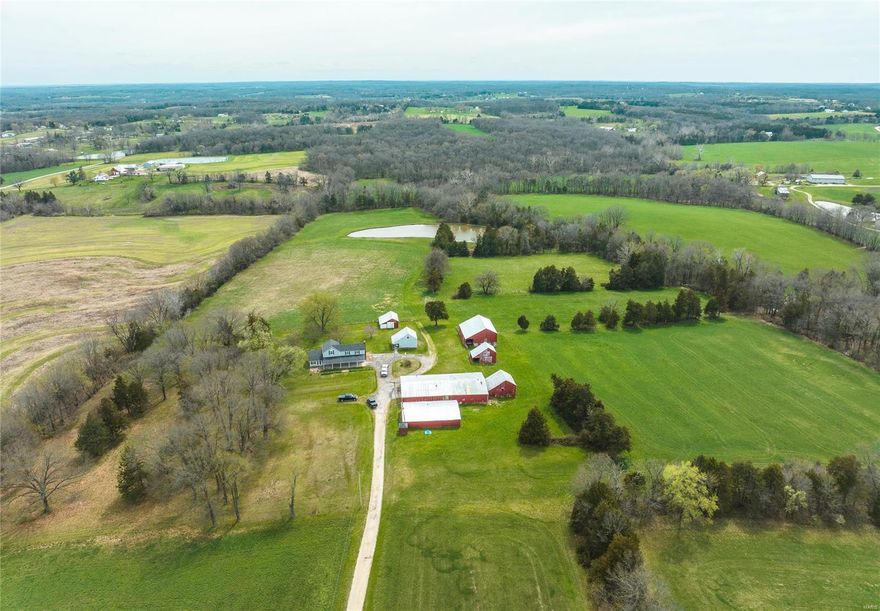 Take a look at this 136ac farm! This property boasts 57ac of beautiful, well-maintained pasture making it an ideal location for farming or ranching. There is a 1ac stocked pond perfect for reeling in crappie, bass & bluegill. The farmhouse on the property features 4beds & 2baths, providing ample space for a family or guests. Additionally there are 8 outbuildings on the property, including 2 grainery barns, well house, hay barn, machine shed, pole barn & a 60x90 barn with concrete floor & 3-phase electric offering plenty of storage space for equipment or livestock. Slaughter Creek runs through the property providing a source of freshwater. The property is also home to a diverse range of wildlife, including deer, turkey, squirrels & rabbits.  A great mix of timberland can be found on the property with trees such as white, black, & red oak, hickory & cedar. This creates a beautiful & serene environment perfect for nature lovers or those seeking a peaceful escape from city life.