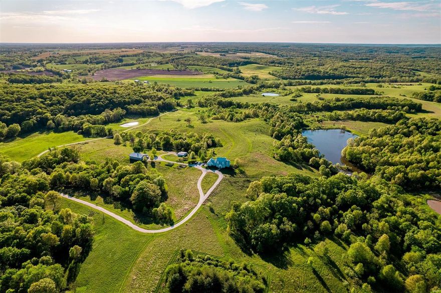 Experience the beauty of nature at Buffalo Creek Farm, located in the picturesque hills of Pike County, Missouri, just an hour north of St. Louis. This magnificent property features a lodge with 6 bedrooms and 4.5 bathrooms, elegantly rustic and perfect for entertaining. Enjoy breathtaking views of a giant field of pollinators and wildflowers, and watch the sunset over the knobs of Pike County from the back covered porch. The seller's passion for bees, bugs, birds, and all of the creatures and plants that can be grown in this area has created an impressive ecosystem that has benefited the deer and turkey. This turn-key family farm is a one-of-a-kind generational opportunity, with furniture, fixtures, equipment, and supplies included. Don't miss out on becoming a part of the Buffalo Creek legacy.