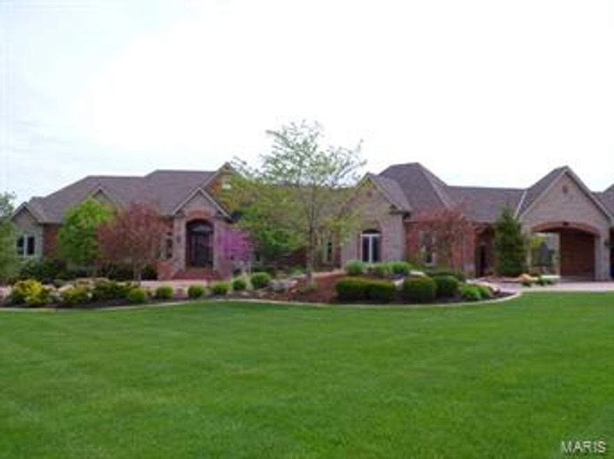 Exquisite in every sense! Exceptional craftsmanship inside and out! Brick and stone exterior w/over 7500 sq ft of living area for family and entertaining. Astonishing details from the hand scraped hickory floors, extensive crown molding throughout, archways, columns, solid wood doors, tongue & groove wood ceilings is just the beginning. Custom gourmet kitchen w/granite, prep sink, 8-burner gas stove & double ovens, pantry, planning desk & more! Luxury master suite w/coffered ceilings & sitting room. Expansive master bath w/jetted soaking tub, walk-in steam shower w/floor to ceiling tile and glass block shower, separate vanities
and walk-in closets. LL features rec room w/brick columns and arches, a stone wall, bar w/glass block, family rm w/built-ins, 3bdrms, 2 baths and play room. Walk out to the salt water pool complete with pool bath, lushly landscaped waterfall all overlooking the lake nestled on 3.86 acres. Attention to detail at every turn; must see this one to appreciate!