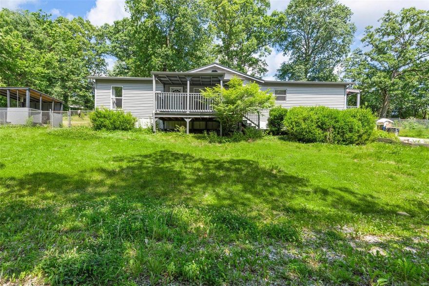 Located on a half acre this 3 bedroom, 2 bathroom home has everything you need. A welcoming front entrance leads you to the cozy family room and dining room. The open floor plan is filled with natural light and includes a vaulted ceiling and a stone fireplace. The kitchen with an adjoining laundry room has plenty of cabinet space for all your kitchen needs. Enter your primary bedroom suite through the French doors and enjoy your private bathroom and 2 closets. This spacious home features 2 additional bedrooms and another full bath. The fenced in backyard includes a shed and a private covered deck just perfect for enjoying the tranquility of nature on this beautiful tree lined property.