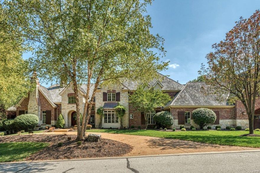 Soaring ceilings, cypress hardwoods & timber beams define the rustic elegance of this spectacular 7500 sf Estate home. Barrel-vaulted entry foyer leads to formal dining room with octagonal ceiling, study with cast stone fireplace & built-in bookcases & stunning great room with 19’ beamed cathedral ceiling, full-height stone fireplace & expansive windows with unsurpassed views. Designer kitchen featuring granite countertops, alder wood cabinetry, premium appliances, butler’s pantry & planning center adjoins breakfast room with built-in breakfronts & vaulted hearth room highlighted by floor-to-ceiling fireplace. Coffered master bedroom suite with luxury bath with shower spa offers an appealing retreat. The 2nd floor extends the living quarters with 3 additional ensuite bedrooms. Lower Level includes recreation room with wet bar, workout room & ½ bath plus apartment with private entrance. Situated on a 2.2-ac bluff lot with 2 verandas, deck with fireplace, pool & koi pond with waterfall.