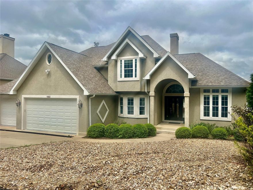 Beautiful Lake front home at the Lake of the Ozarks.  This 6 bedroom, 3.5 bath 2.5 story home has it all !!  Fantastic main channel views,  large open decks, main level master suite, home office, formal dining room,  large main level living room, 2 way gas fireplace, kitchen offers a center island lots of cabinets, granite counter tops.  Lower level with 14 ft ceilings, family room, recreation area, a great bar  with ice machine & wine cooler, lower level 2nd master suite.  A great 2 well concrete dock with 2 pwc slips.  Located near lake side restaurants  and you cant believe  the views.