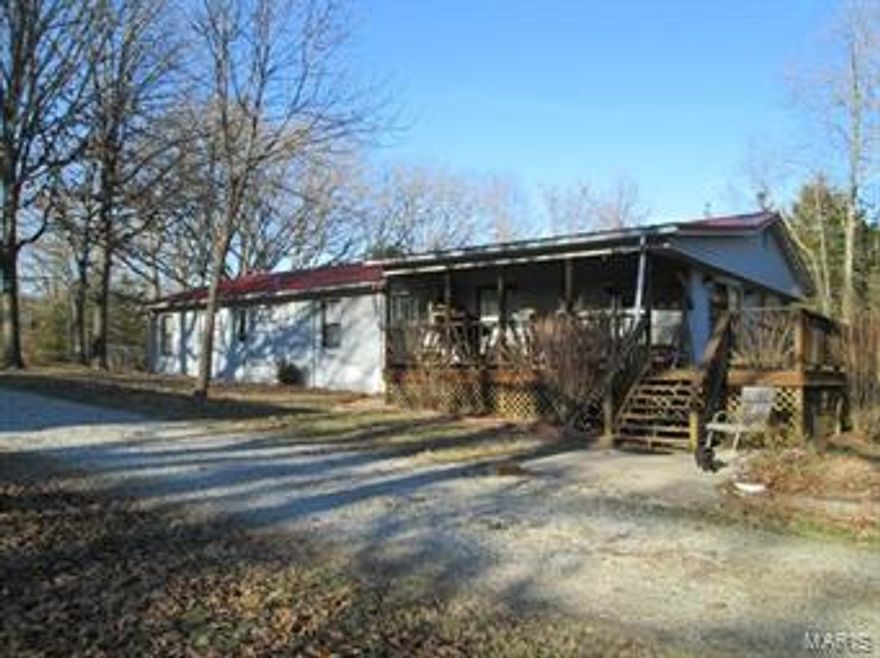 Tons of room in this 3bdrm/1ba home on 23 acres with small pond & shop.   Sellers have recently installed new flooring & done some upgrades.  Home has an open floor plan feel with eat in kitchen, dining rm and lrg living rm with wood stove.  Bonus room can be used as a den/office or additional sleeping rm.  There is a utility rm off the back side of the home with ramp access in case stairs might be an issue.  The shop was once used as a business and has a heated office area.  Property also features an abundance of wildlife with deer stands and a stocked pond and even a small fenced in area for pets.  Conveniently located just a few miles off Hwy 50.